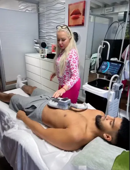 A young man getting EMSculpt muscle stimulation treatment at Lips Boutique® and Beauty Lab in Toronto, ON