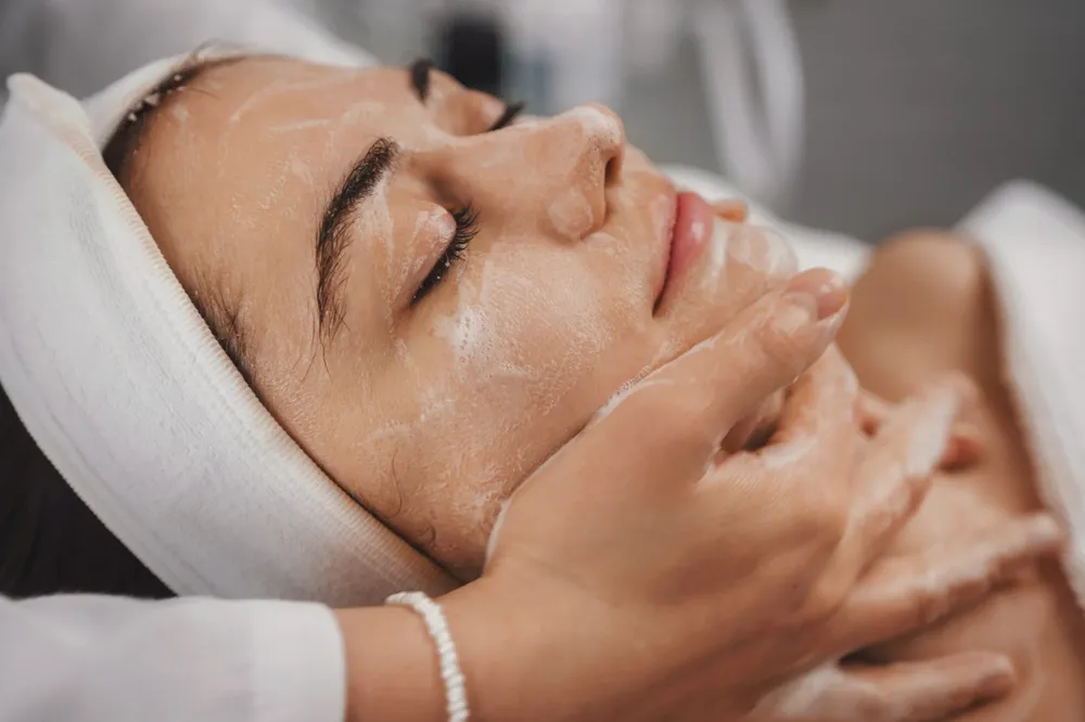 Woman receiving a relaxing facial treatment at a spa